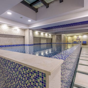 a indoor pool with a tile wall