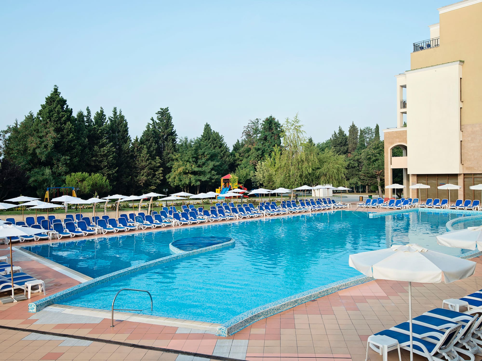 a pool with chairs and umbrellas