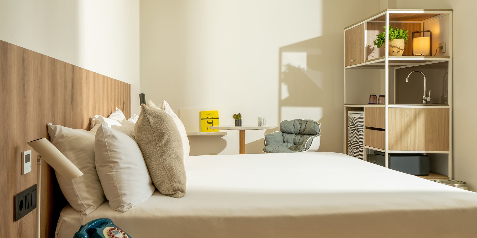 a bed with pillows and a chair in a room