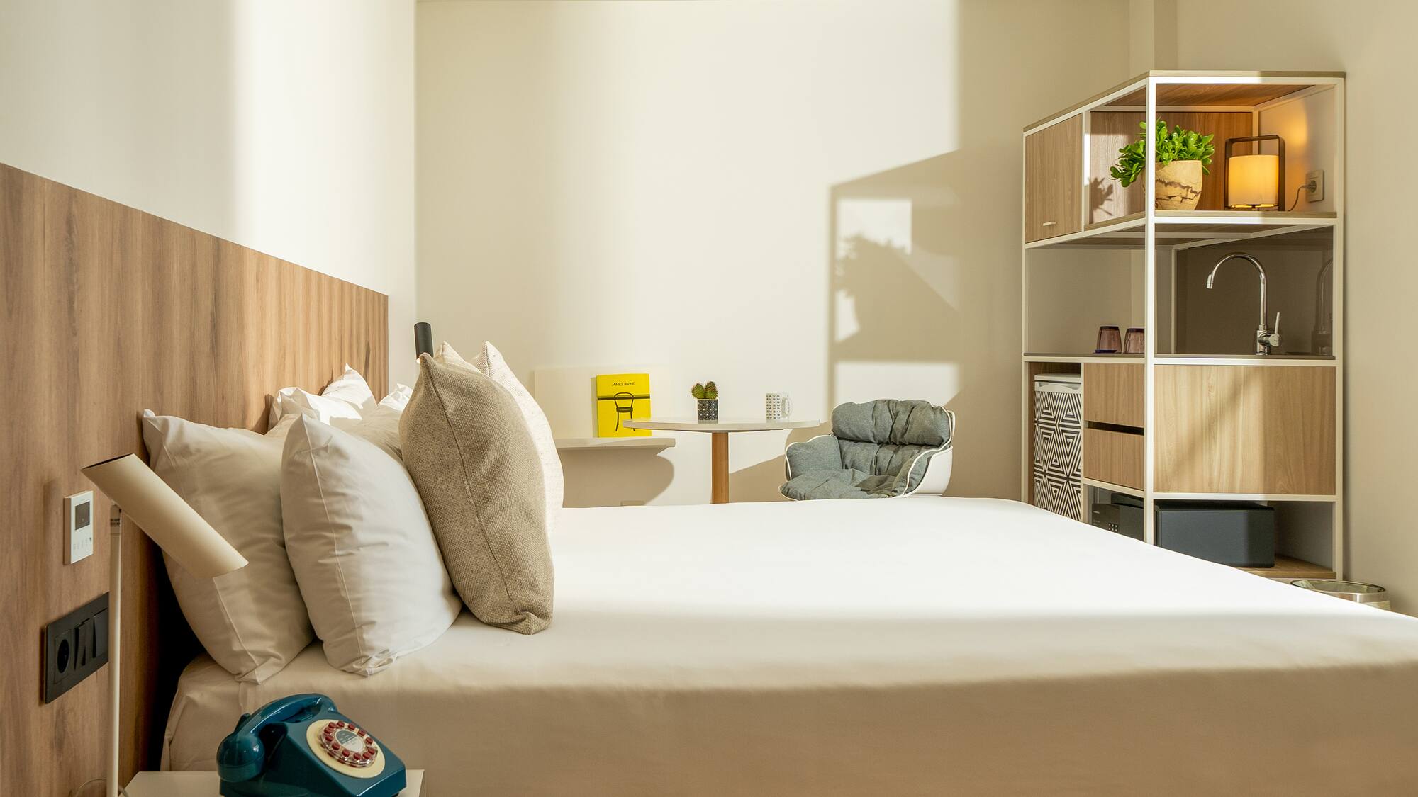 a bed with pillows and a chair in a room