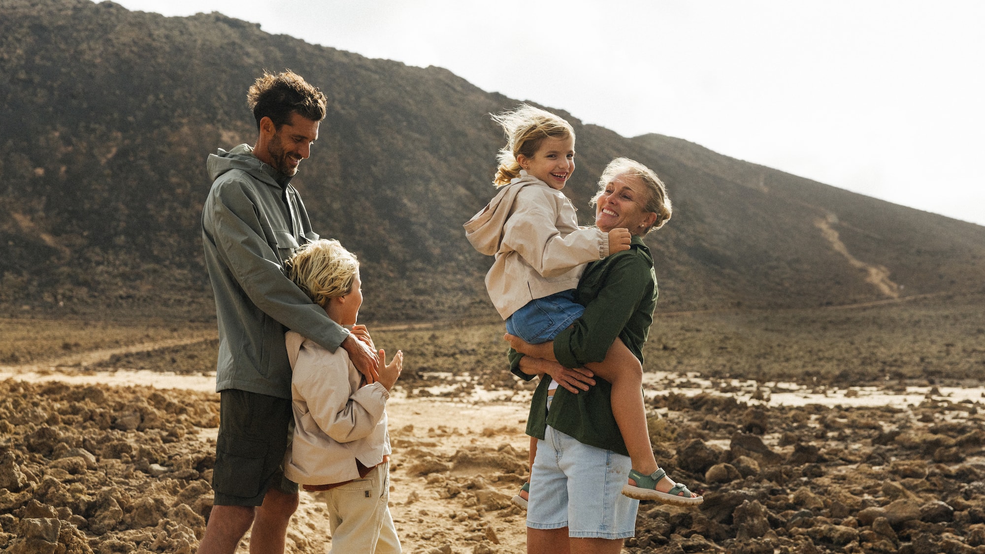 a man holding a woman and two children
