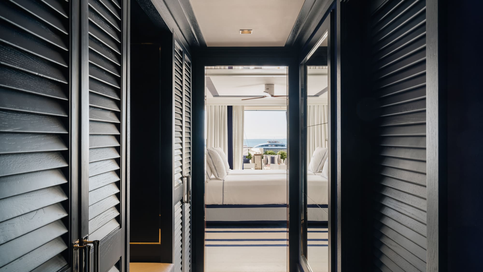 a hallway with a bed and a window
