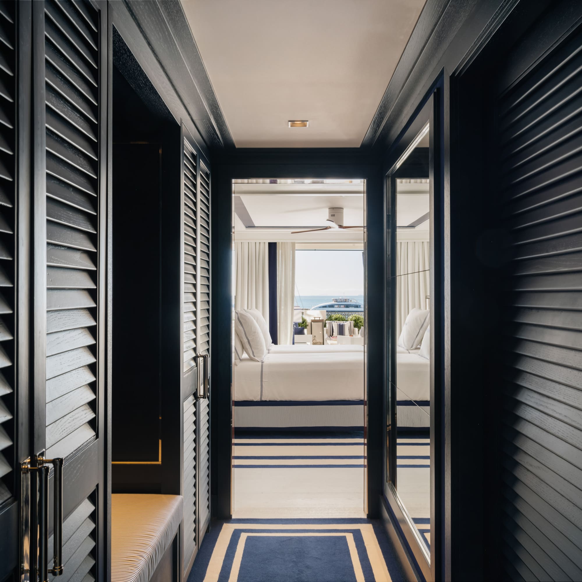 a hallway with a bed and a window
