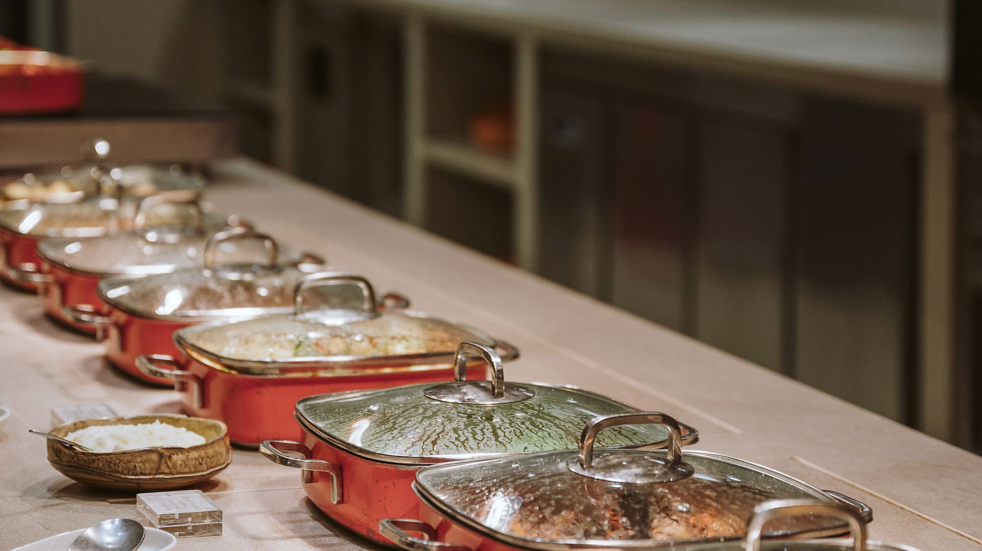 a row of pots with food on a table