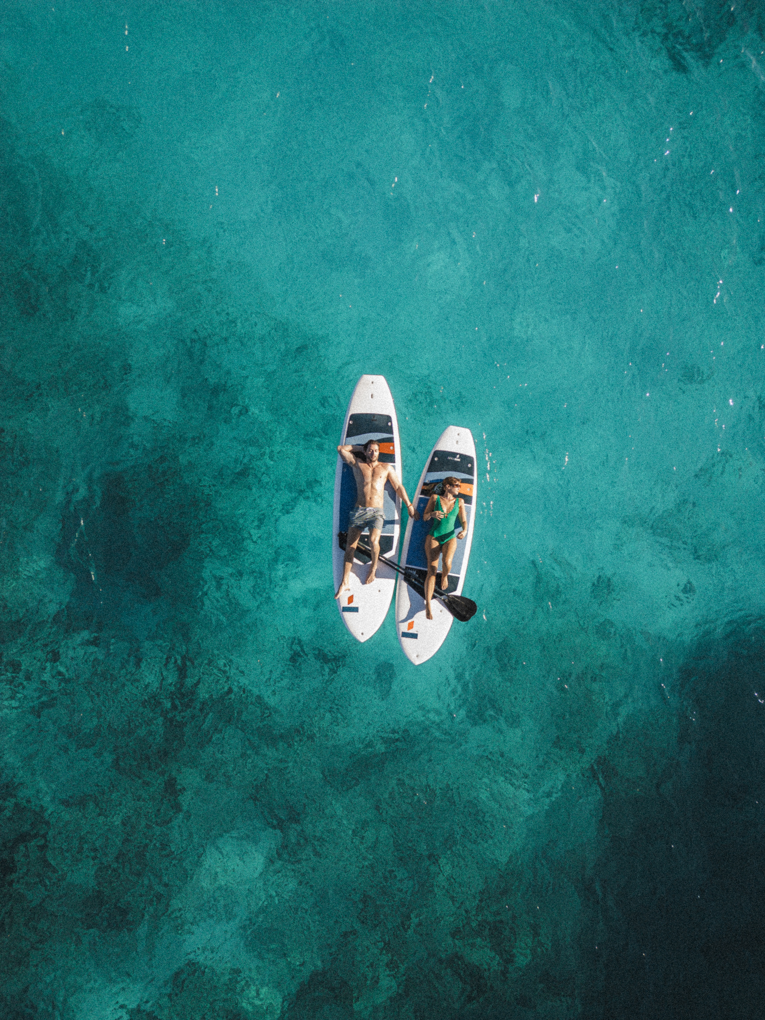 a couple of people on surfboards in the water
