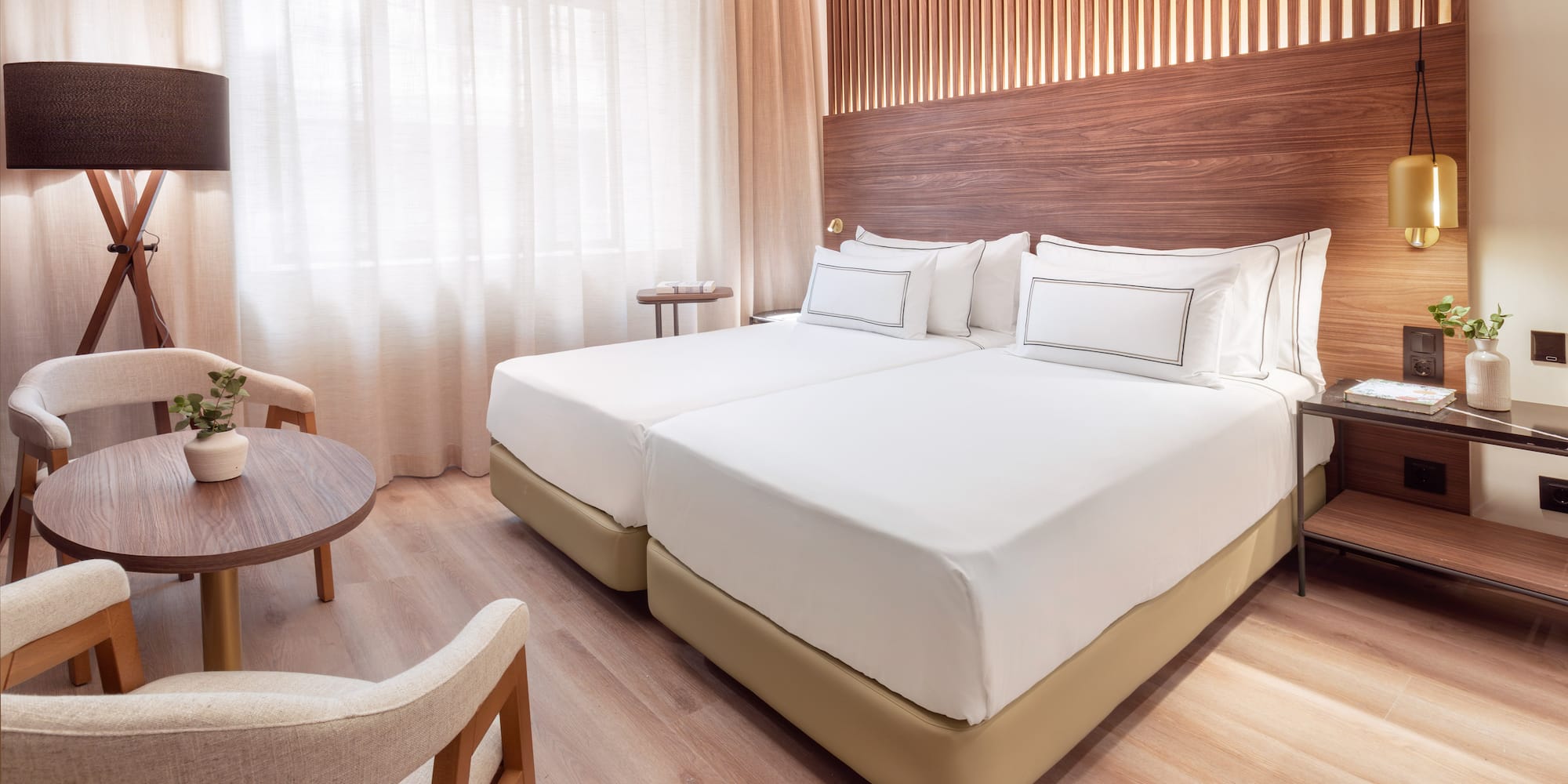 a room with two beds and a table