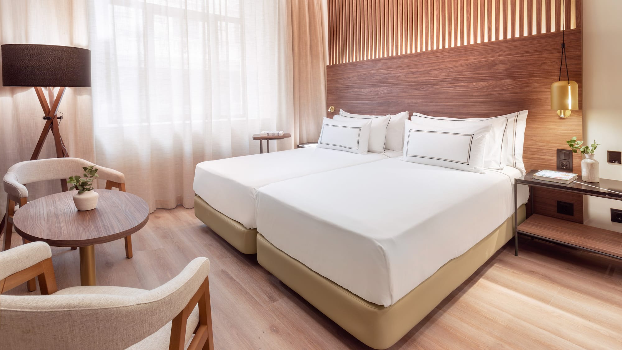 a room with two beds and a table