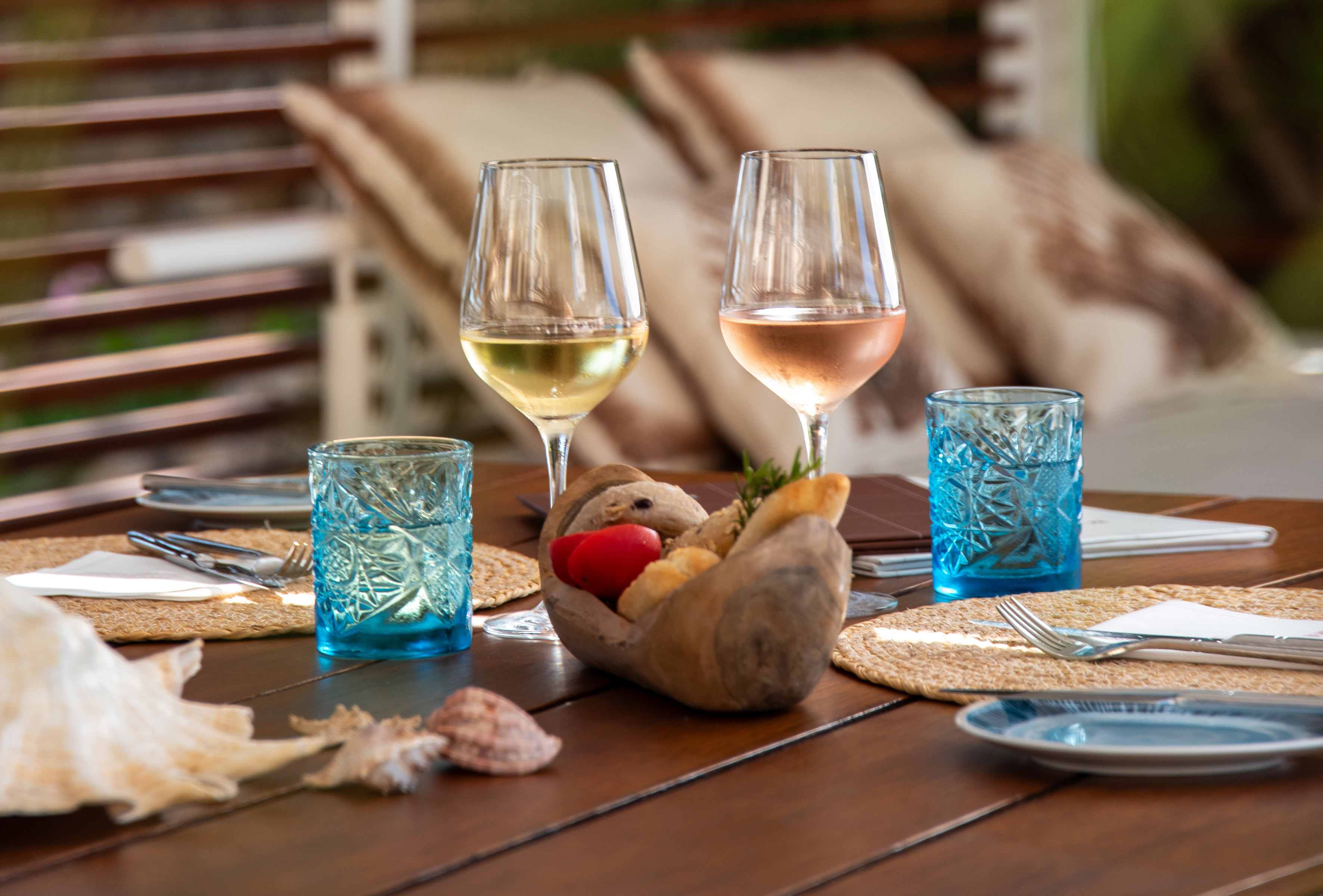 a table with glasses of wine and a bowl of food