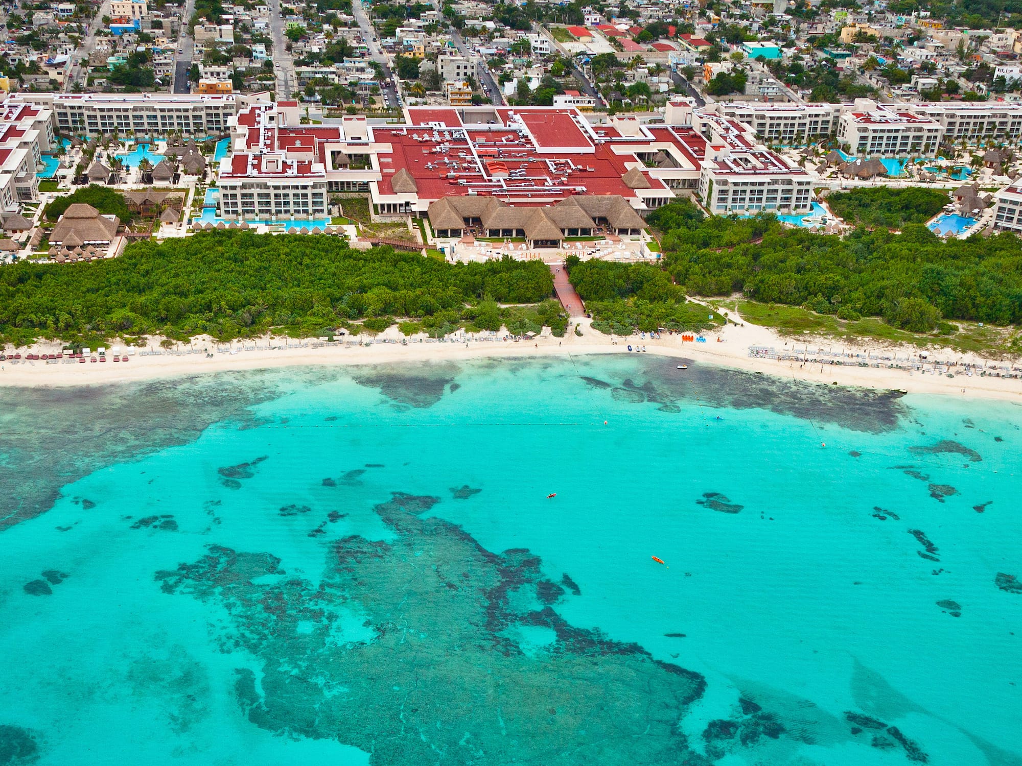 a beach with a building and trees