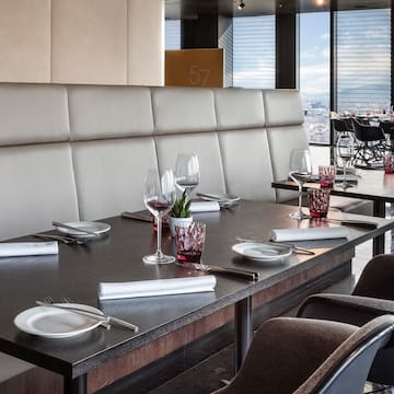 a table with wine glasses and plates in a restaurant