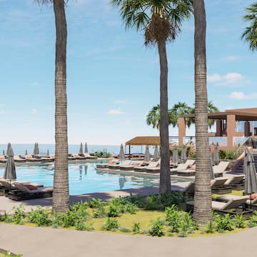 a pool with palm trees and lounge chairs