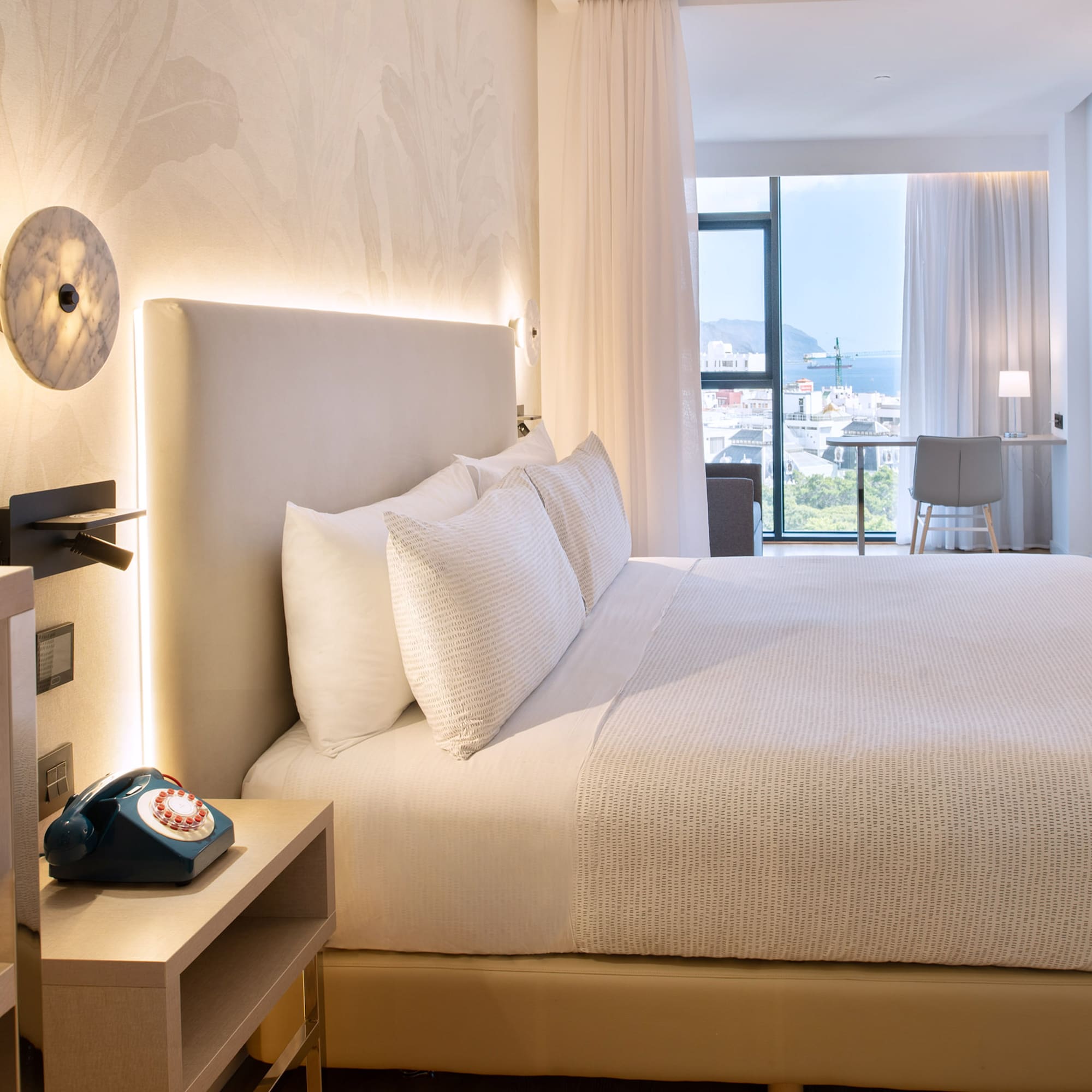 a bed with a telephone and a table in a room