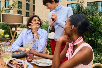 a group of people at a table with wine