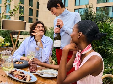 a group of people at a table with wine