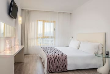a bedroom with a bed and a desk