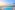 Infinity pool overlooking ocean at sunset, with a palm tree and distant coast.