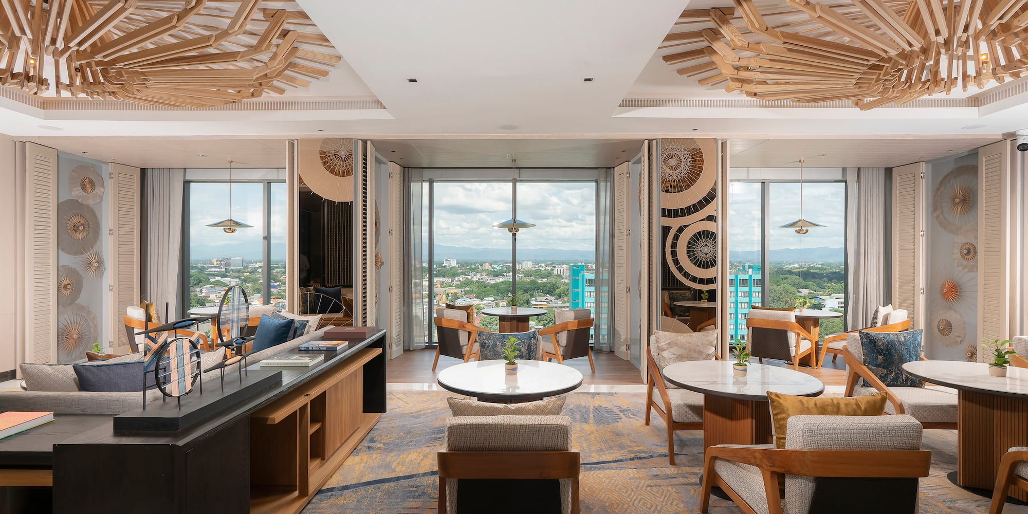 a room with tables and chairs and a view of a city