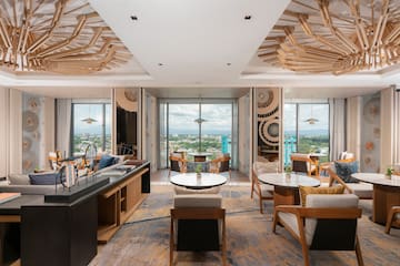 a room with tables and chairs and a view of a city
