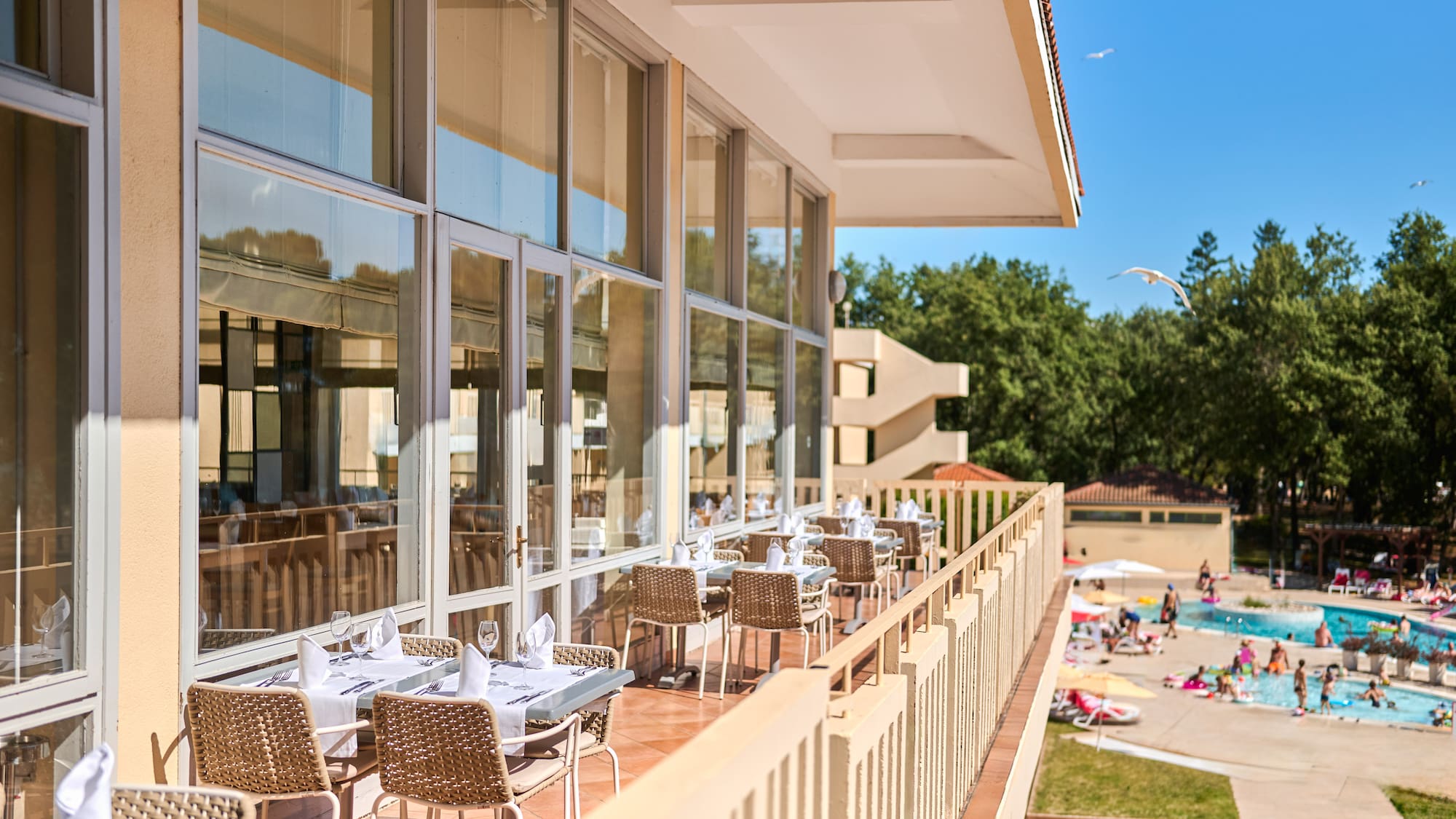 a restaurant with tables and chairs on a balcony