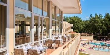 a restaurant with tables and chairs on a balcony