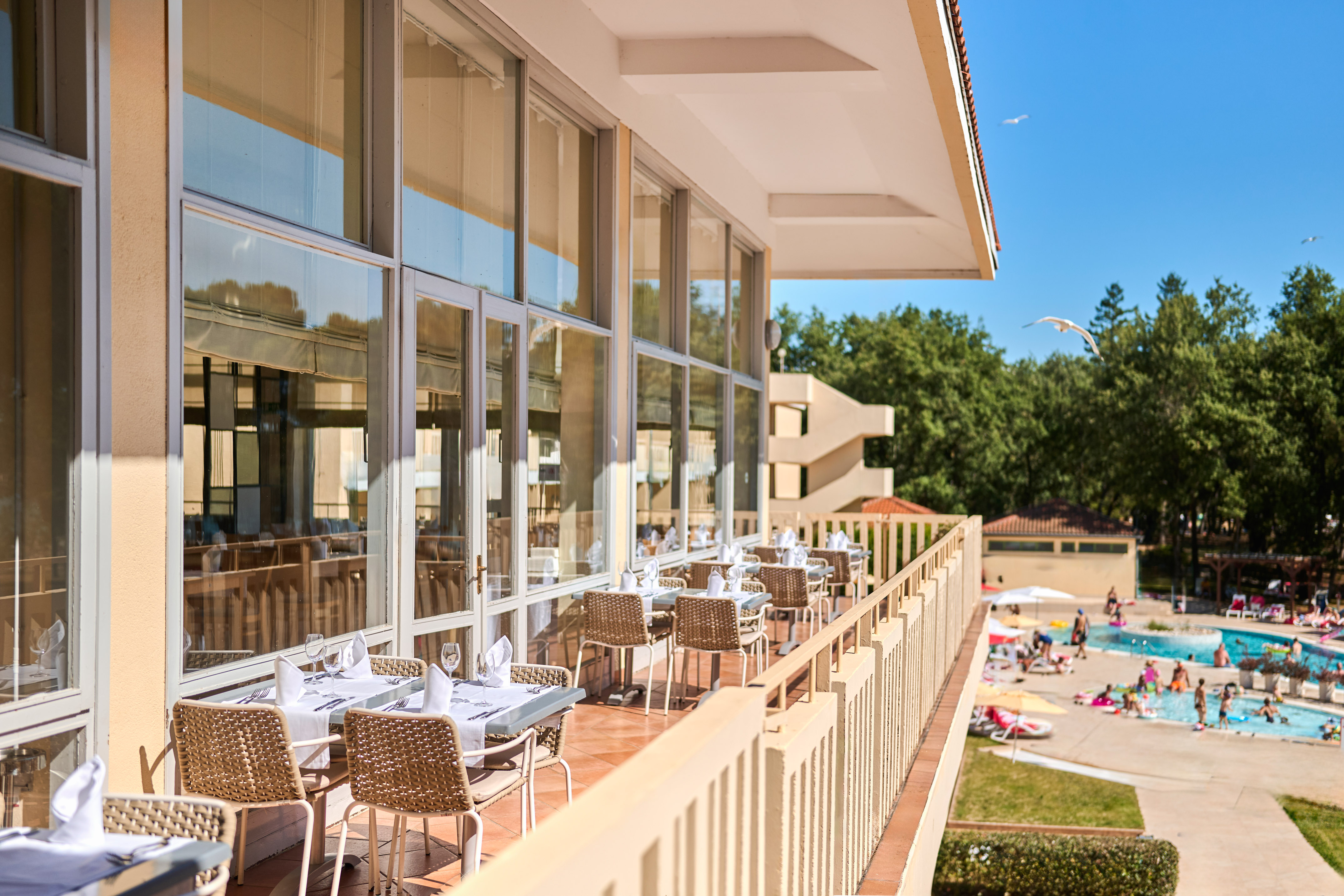 a restaurant with tables and chairs on a balcony