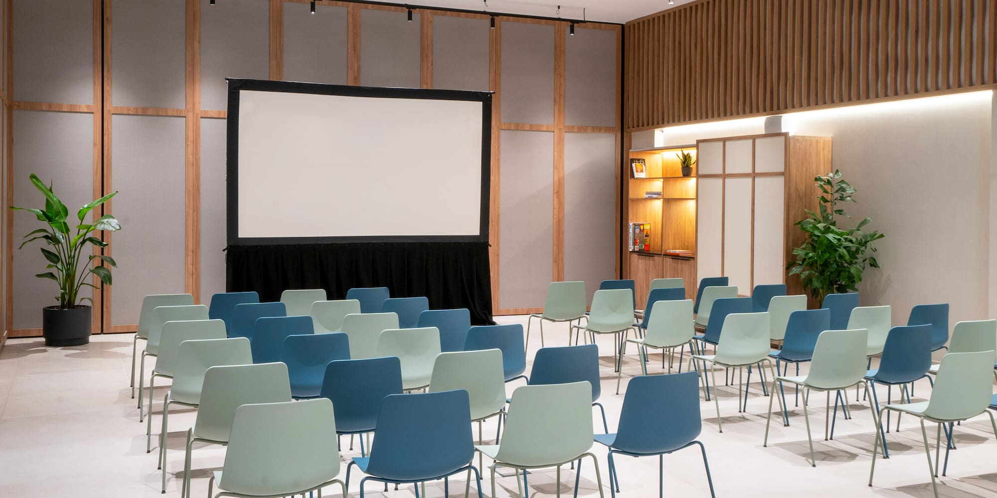 a room with chairs and a projector screen