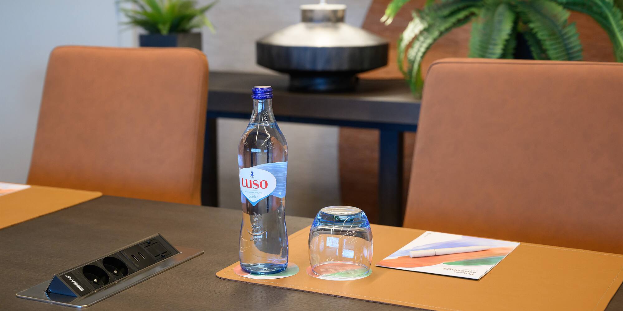 a bottle and glasses on a table