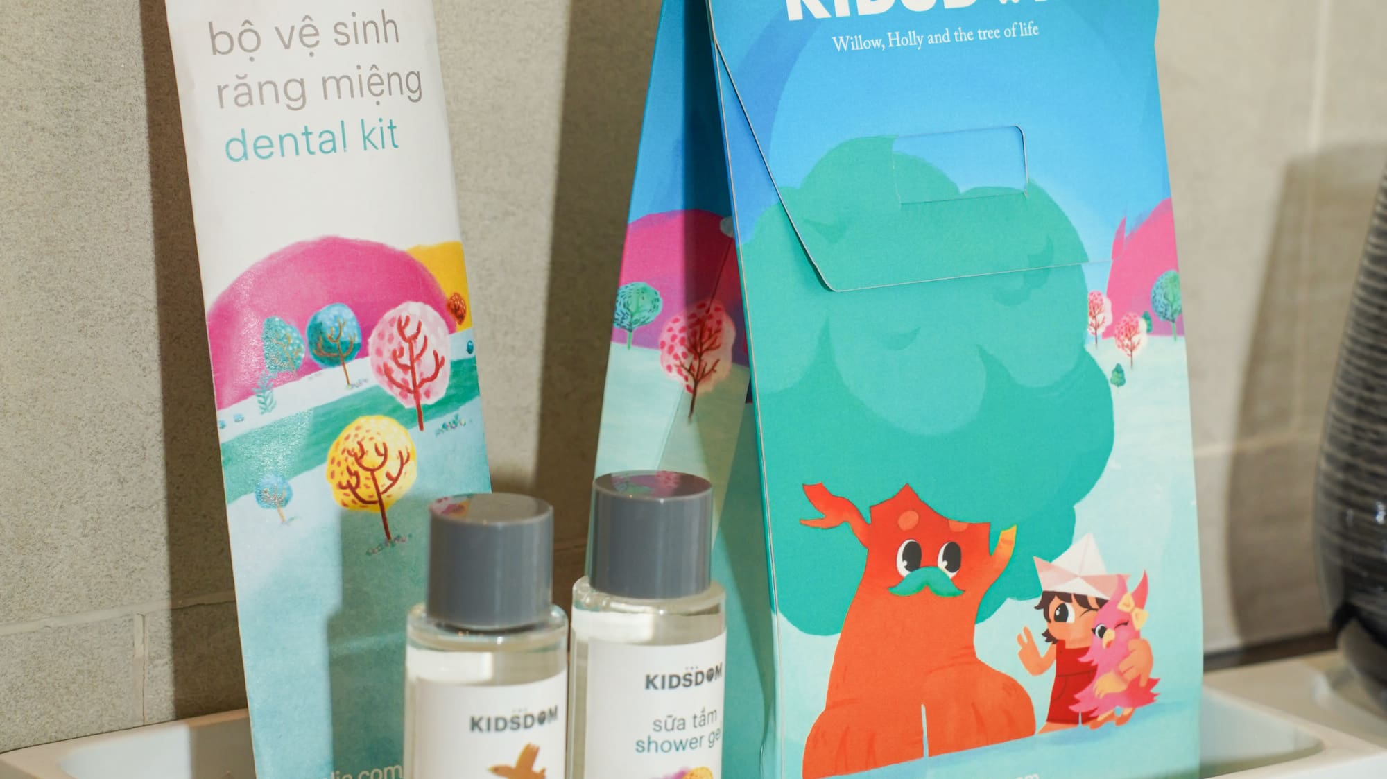 a small white tray with a bag and bottles of shampoo on it