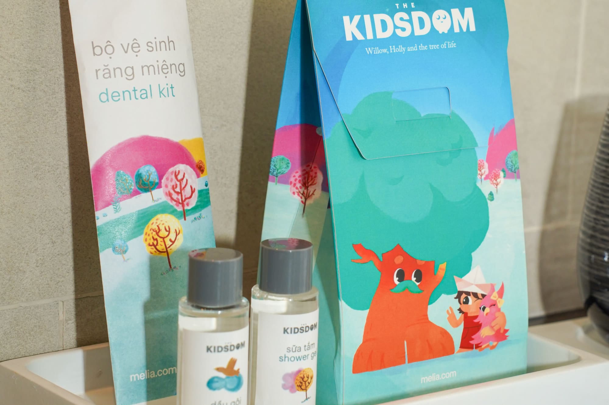 a small white tray with a bag and bottles of shampoo on it