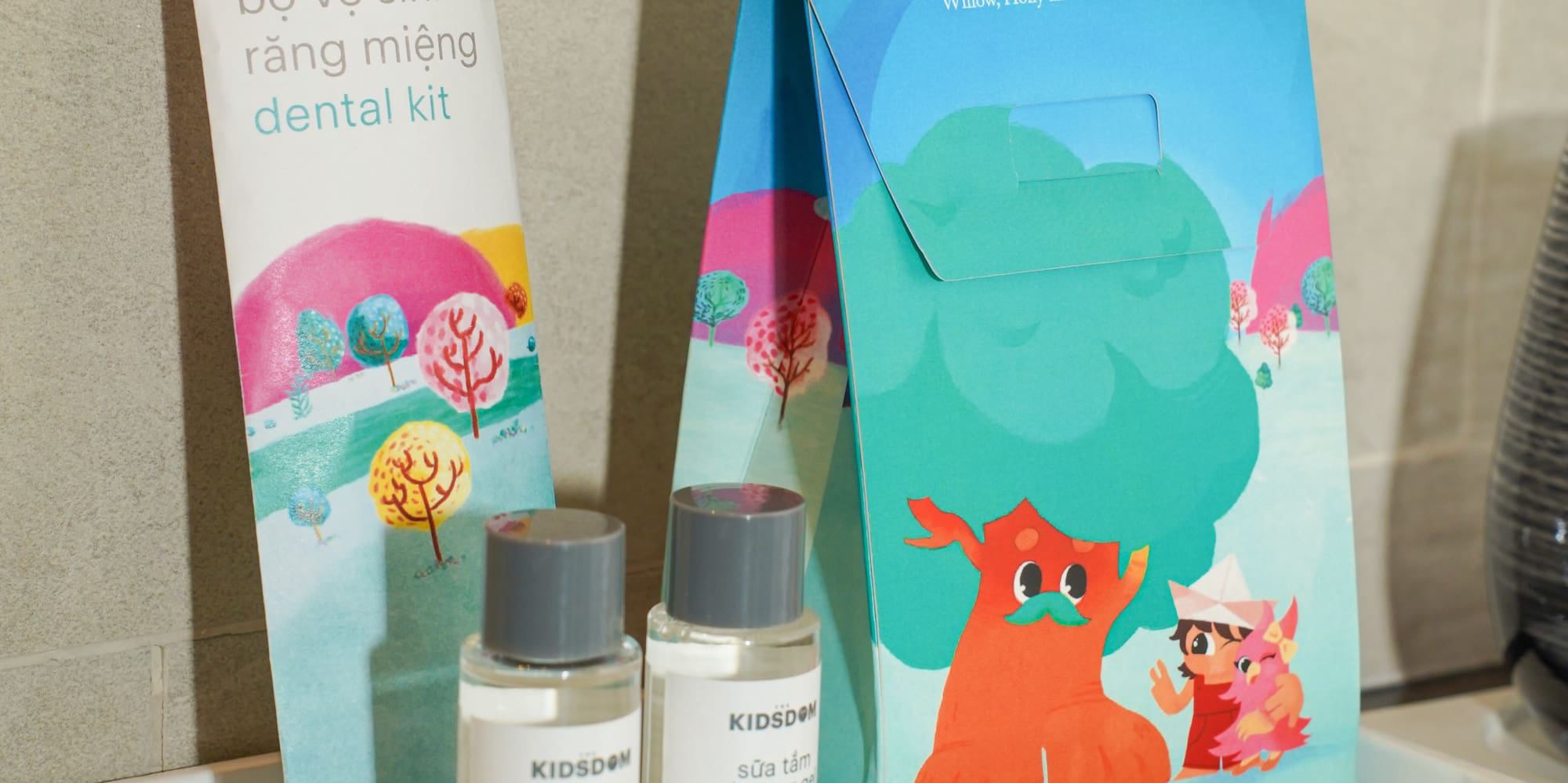 a small white tray with a bag and bottles of shampoo on it