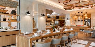 a restaurant with a long table and chairs