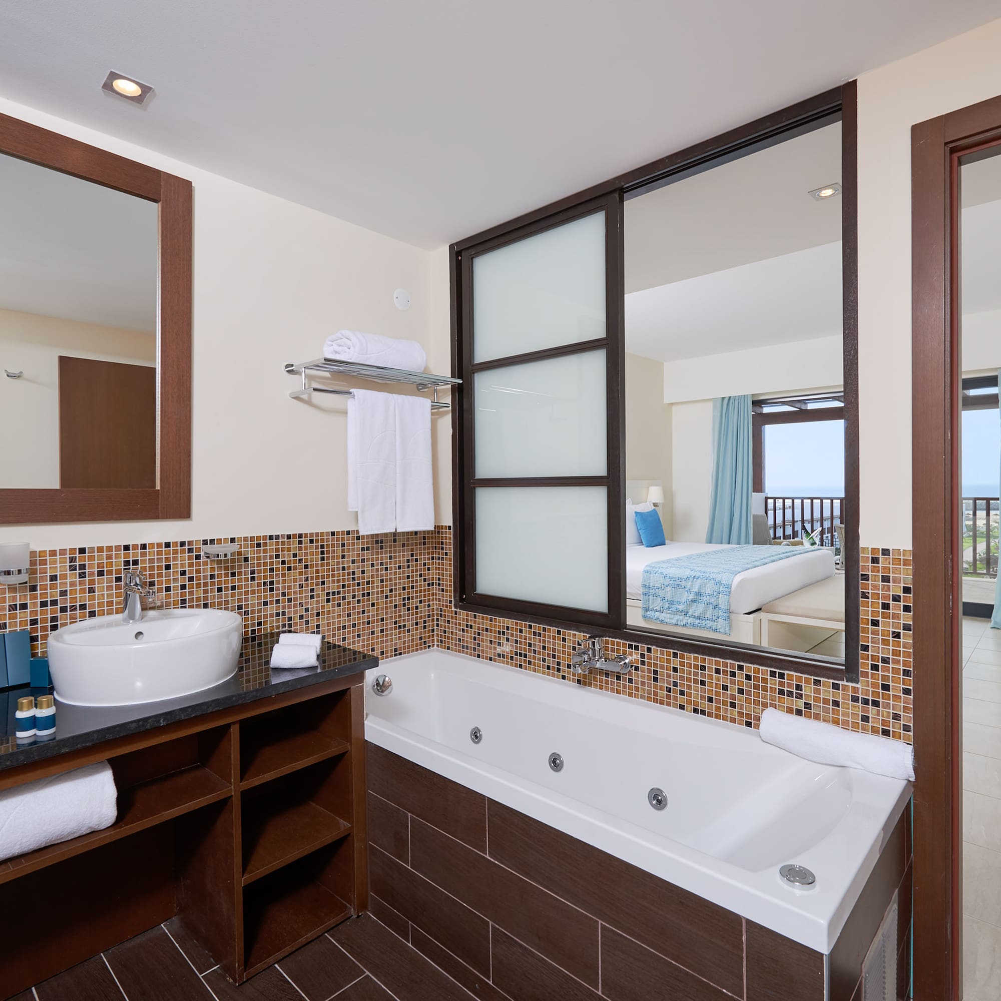 a bathroom with a bathtub and mirror