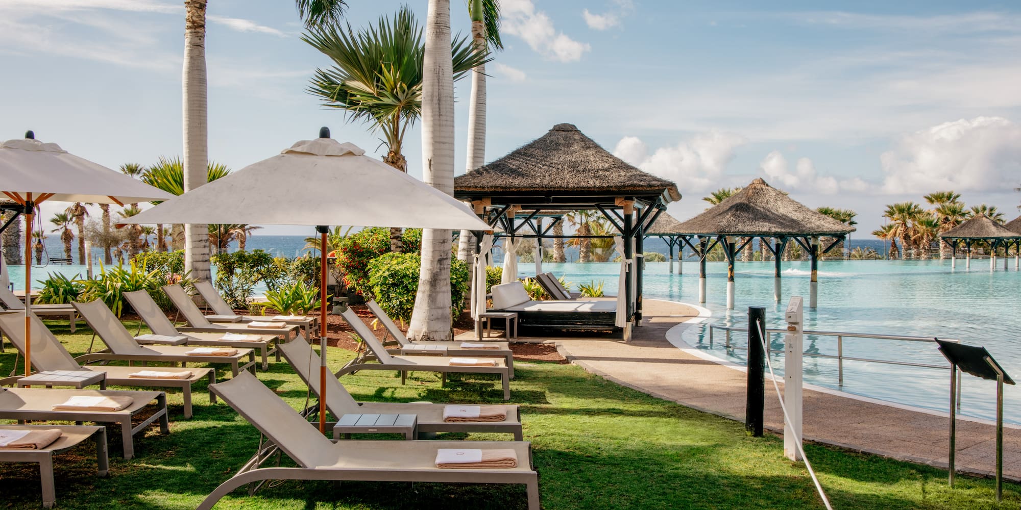 a pool with lounge chairs and umbrellas