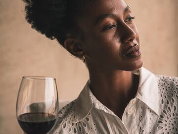 a woman holding a glass of wine