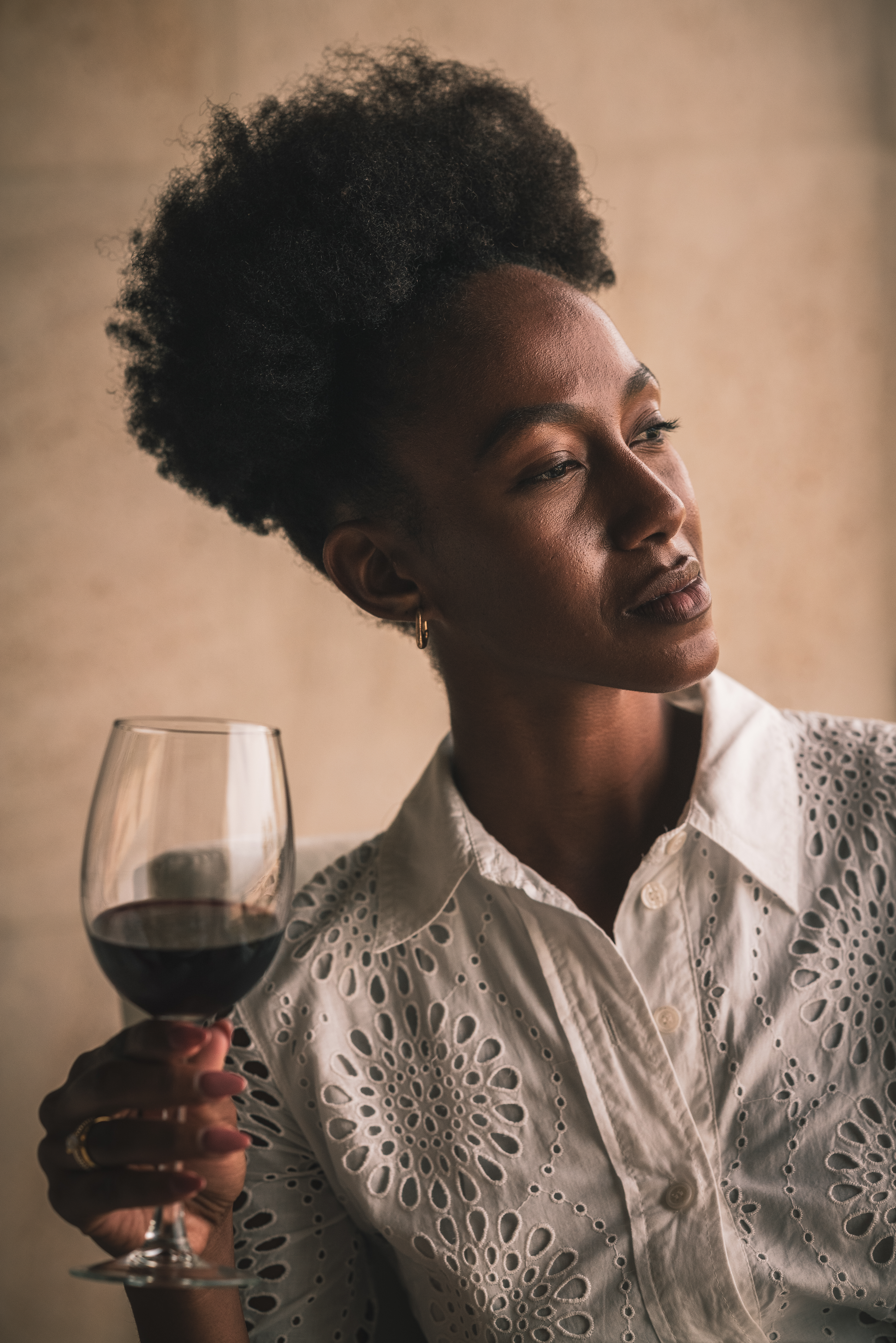 a woman holding a glass of wine