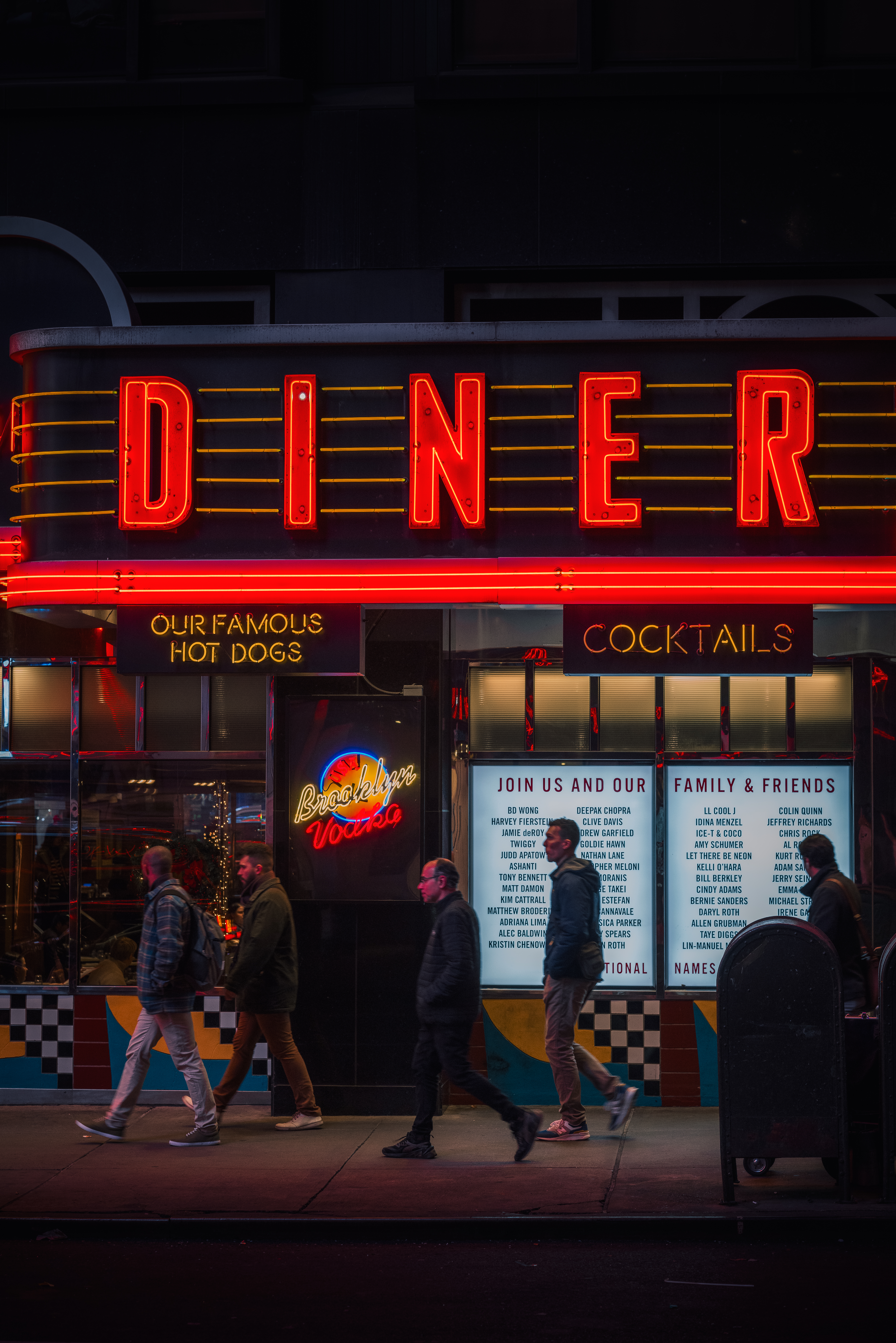 a group of people walking past a restaurant