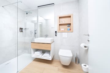 a bathroom with a glass shower and a sink
