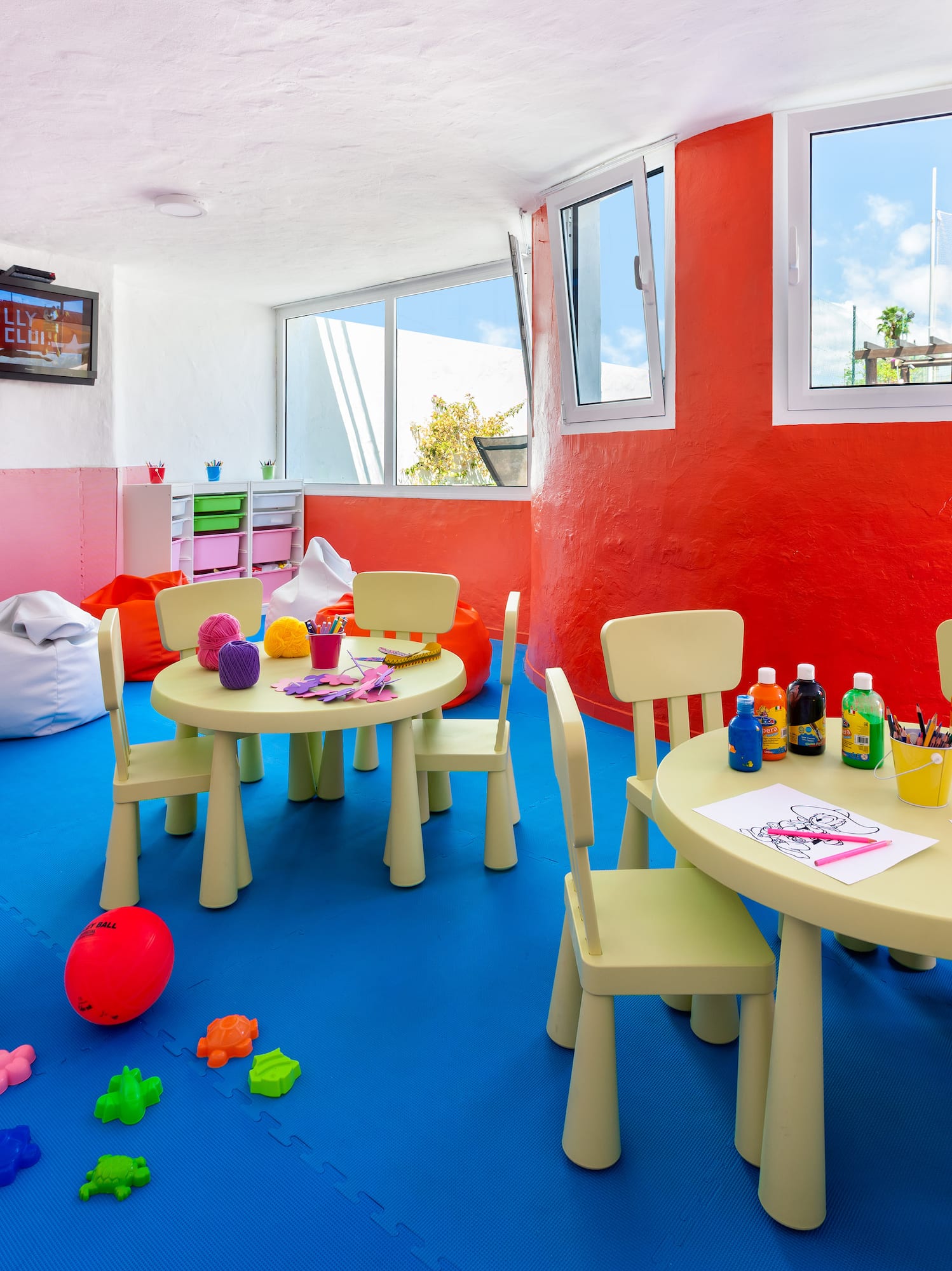 a room with a table and chairs and toys