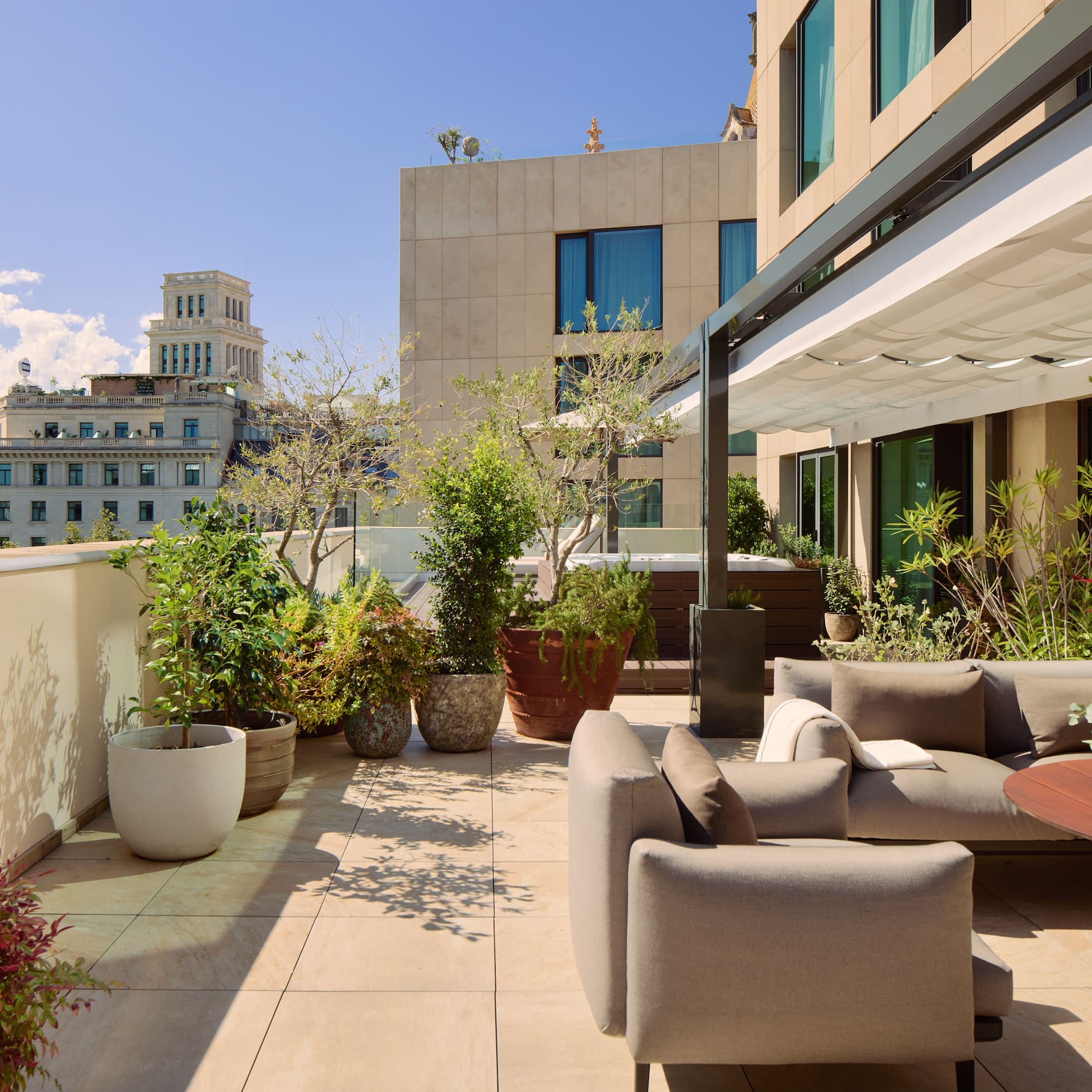 a patio with a couch and plants on it