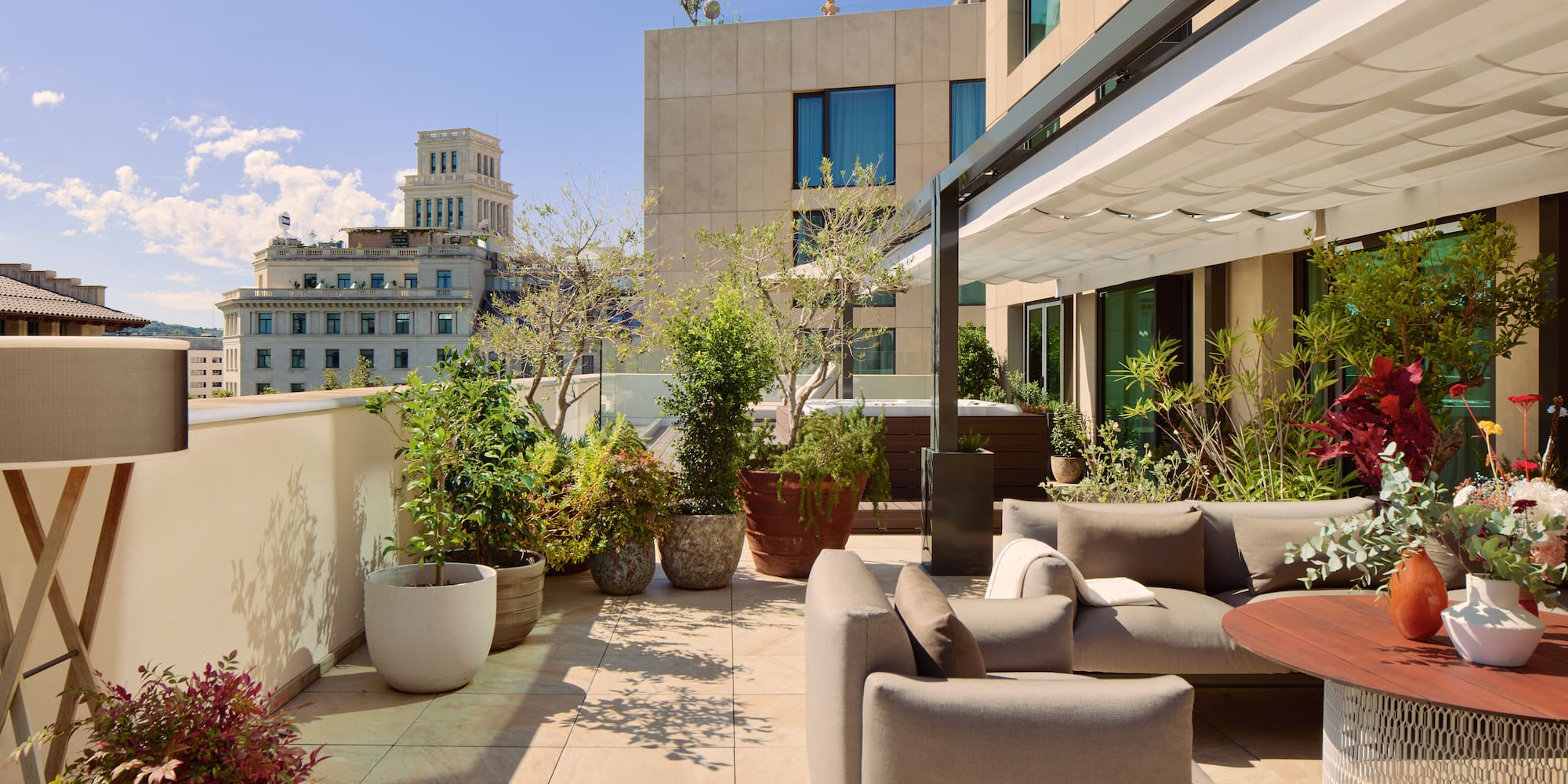 a patio with a couch and plants on it