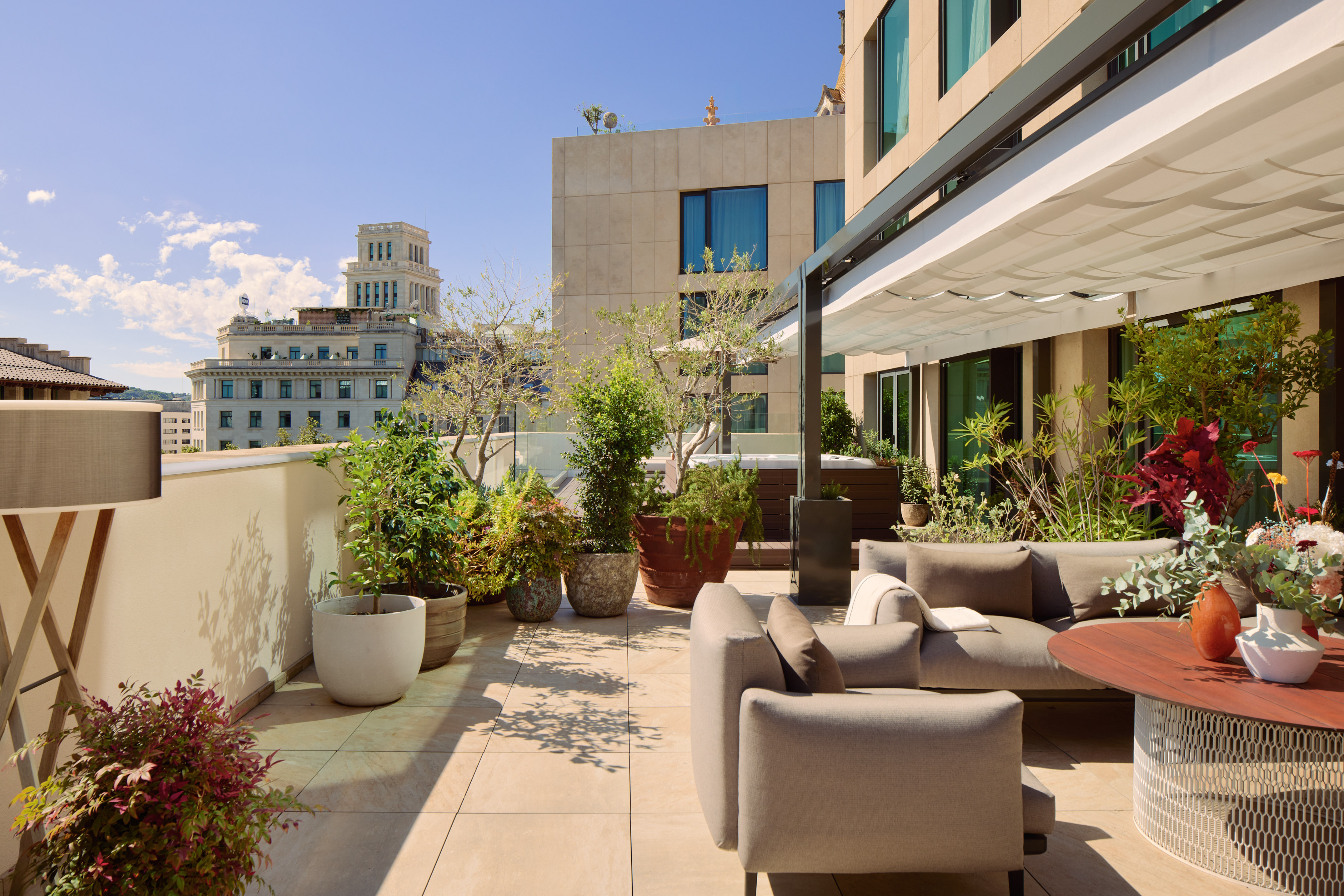 a patio with a couch and plants on it