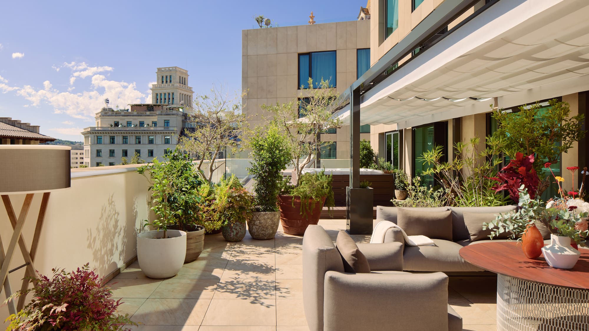 a patio with a couch and plants on it