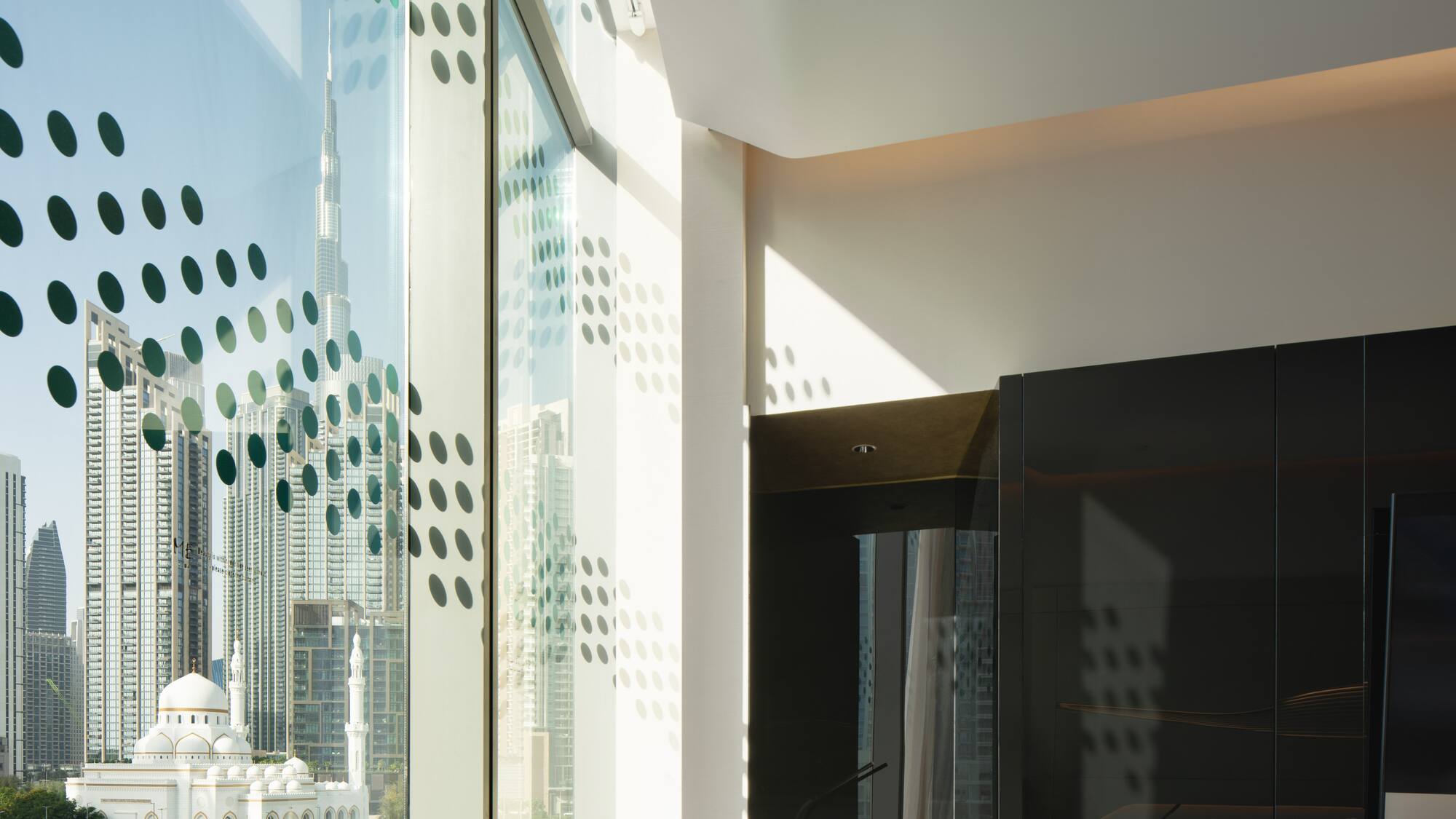 a room with a large window and a city view