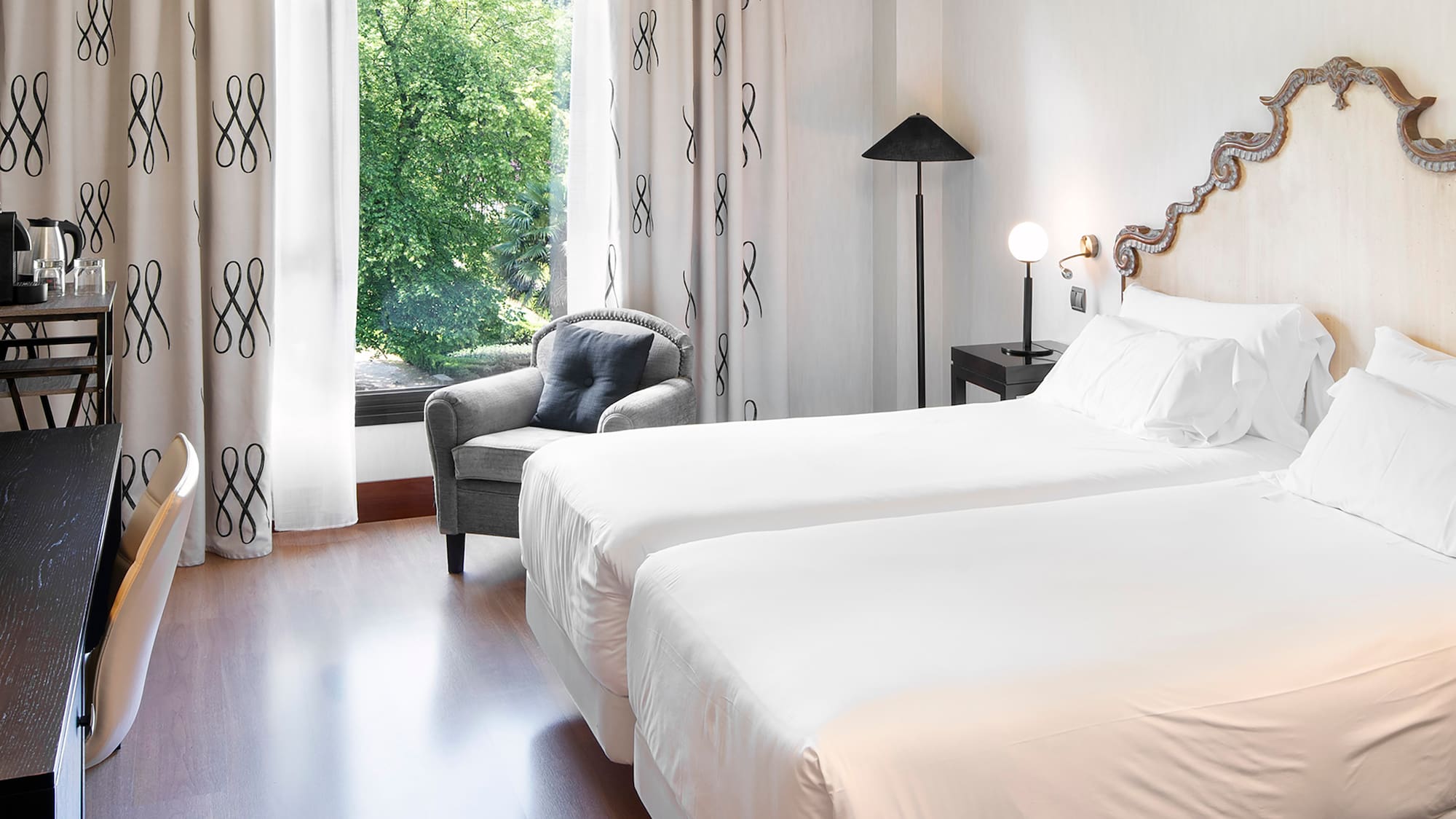 a room with two beds and a chair