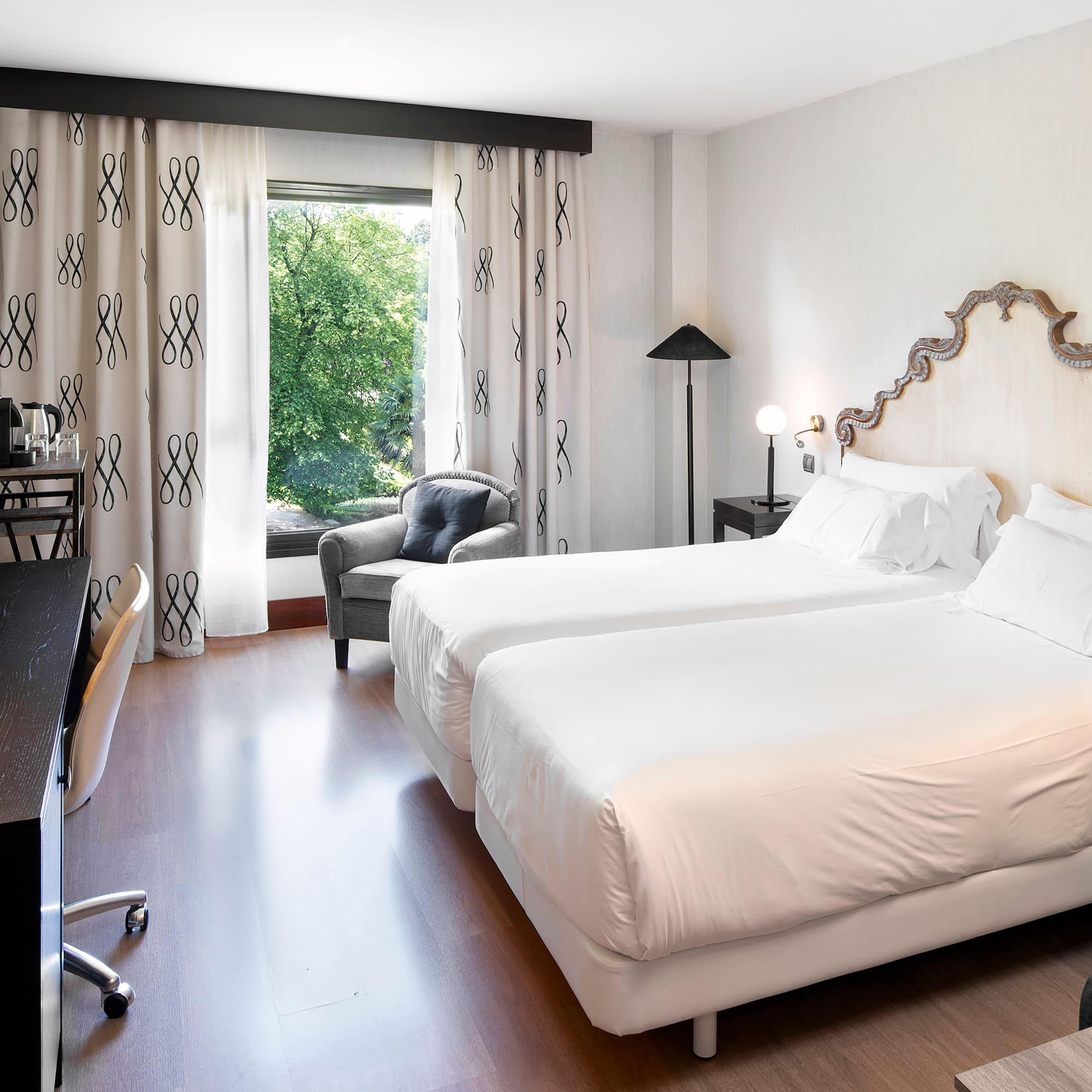 a room with two beds and a chair