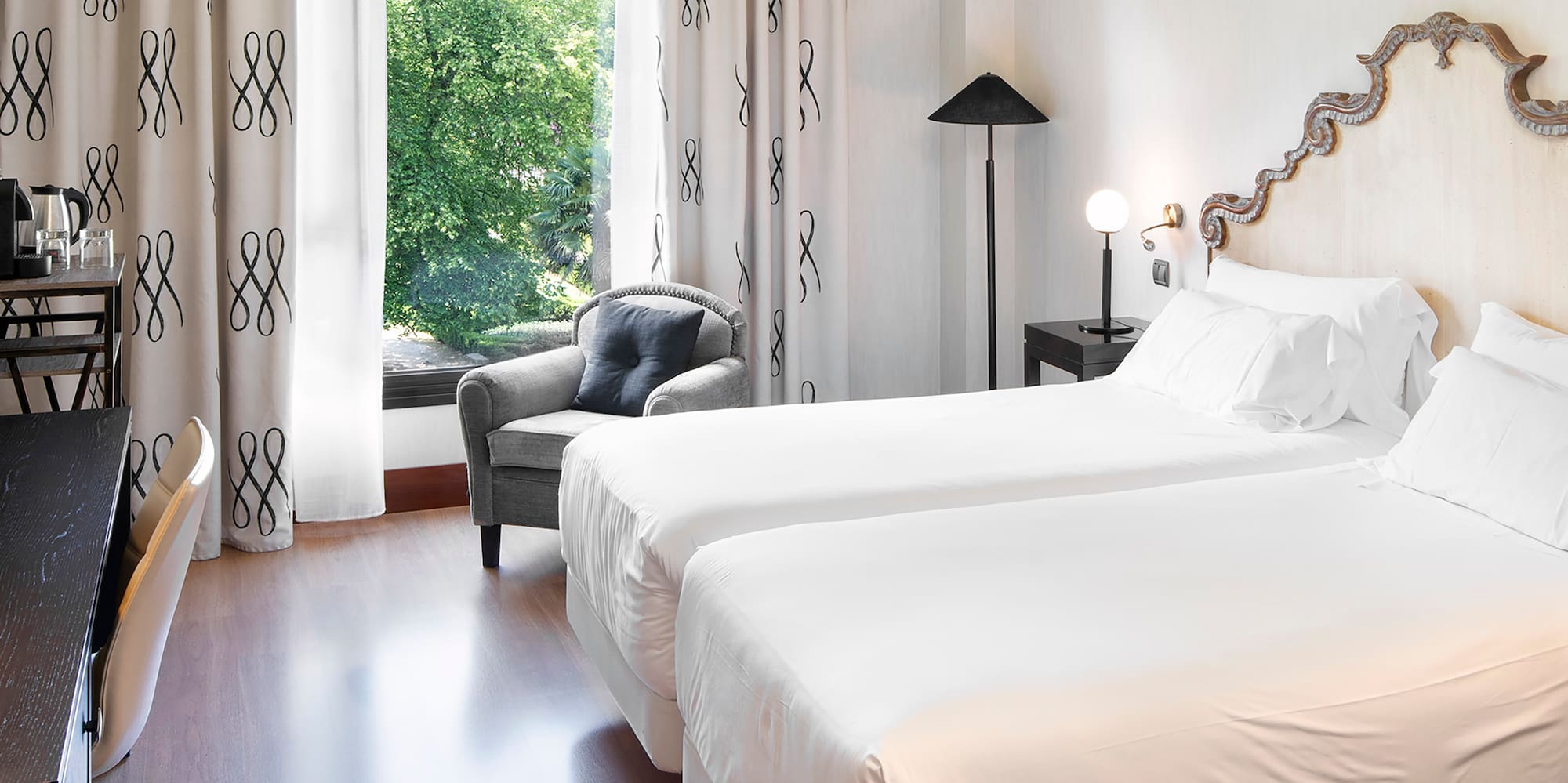 a room with two beds and a chair