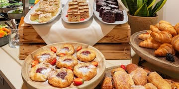 a table with different pastries and desserts