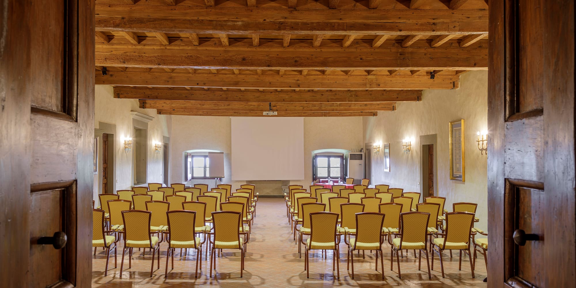 a room with many chairs and a projector screen
