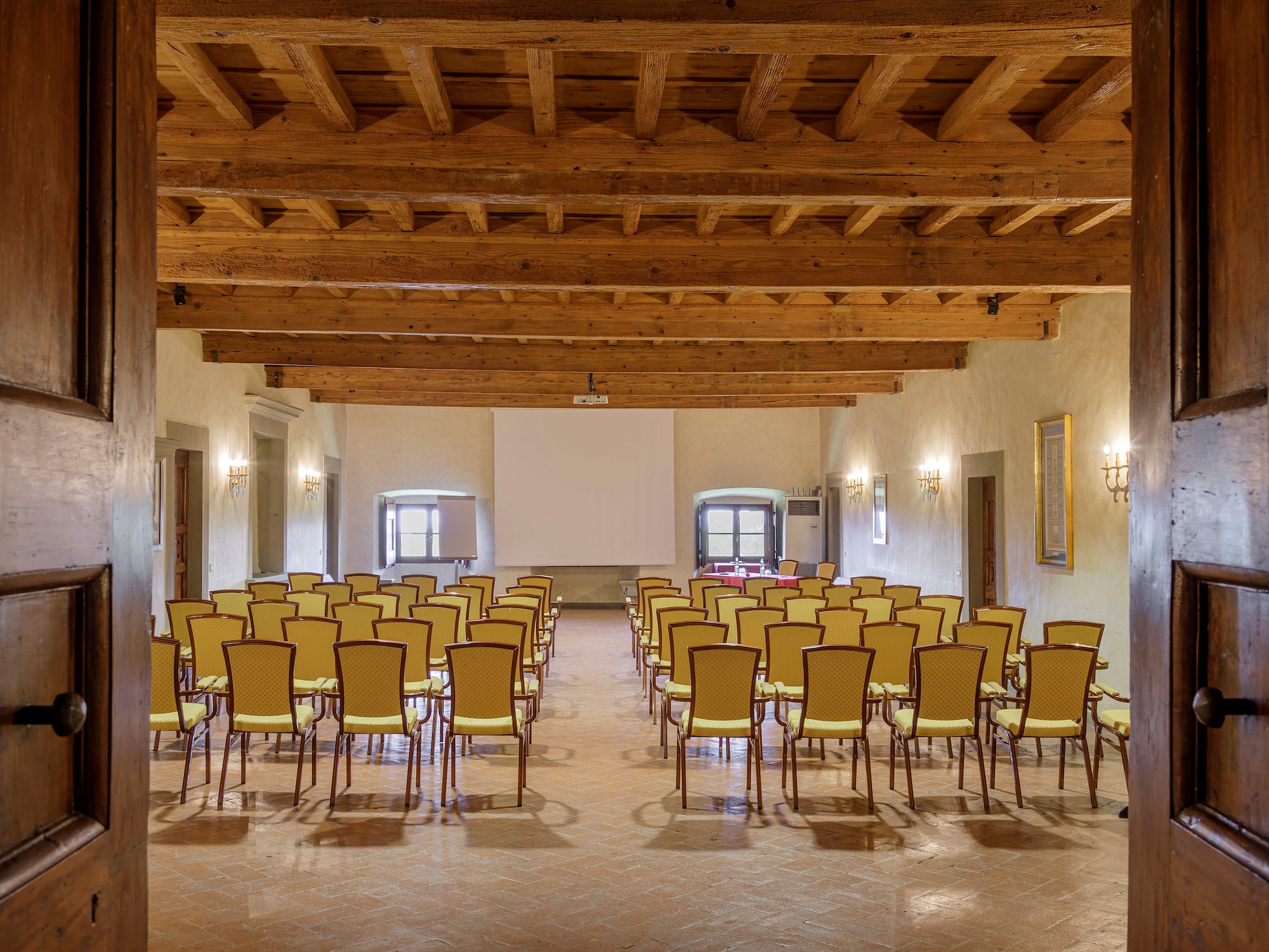 a room with many chairs and a projector screen