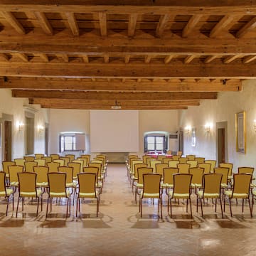 a room with many chairs and a projector screen